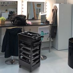 a room with several different types of hair products on the table and in front of it is a mirror