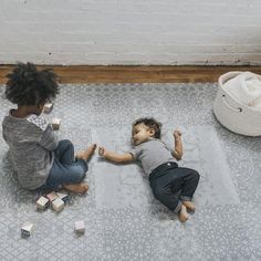 two children playing with blocks on the floor