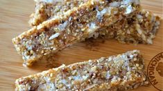 some kind of granola bar sitting on top of a wooden cutting board