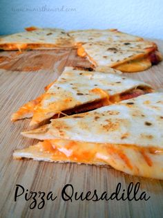 several slices of pizza sitting on top of a wooden cutting board with cheese and sauce