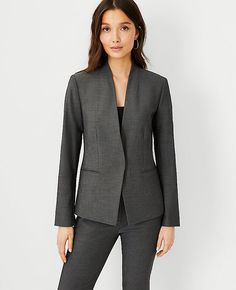 Refined four-way stretch holds its shape while flattering yours - so you stay polished and comfortable from A.M. to P.M. Stand collar. Long button-open sleeves allow for versatility in styling. One button front. Front besom pockets. Back vent. Lined. Shop all Bi-Stretch Suiting,Bullet2:23" long,Imported:Imported,Fit:Tailored fit,Fabrication:66% Polyester, 28% Rayon, 6% Spandex,Garment Care:Machine Washable The Petite Cutaway Blazer in Bi-Stretch by Ann Taylor Size petite - 10 Dark Grey Women's B Knitted Suit, Women's Blazers, Professional Wardrobe, Gray Suit, Fitted Blazer, Womens Blazers, Suit Separates, Grey Women, Chic Woman