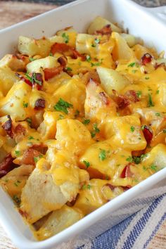 a casserole dish with potatoes, bacon and cheese