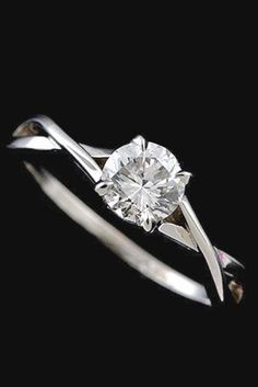 a white gold ring with a diamond in the center