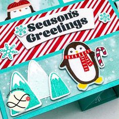 a close up of a christmas card with penguins