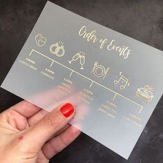 a person holding up a silver card with gold lettering on it that says, order and events