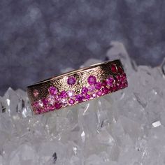 Solid 14 gold band, set with an ombré dripping of natural Sapphires in rainbow hues. Also available with Tsavorite Garnets, and Diamond. The gemstones are set 3/4 around the band to accommodate for future resizing if needed! Inspired by the the volcanic forces used to create the Hawaiian Islands. The Pele band has an organic feel, that is substantial and ideal for everyday wear. 7mm wide and 2mm thick. The gold comes textured in either a raindrop, or brushed finish. But can also be finished to a Pink Sapphire Jewelry, Tsavorite Ring, Tsavorite Garnet, Right Hand Rings, Hawaiian Islands, Sapphire Jewelry, Natural Sapphire, Gold Band, Pink Sapphire