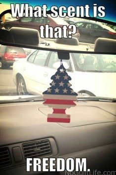 an american flag on the dashboard of a car with text that reads, what scent is that?