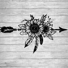 an arrow and sunflower on a wooden background with arrows in the shape of flowers