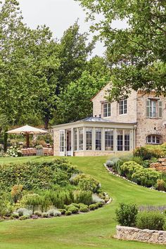 a large house surrounded by lush green grass and trees