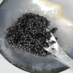 a spoon with some black beads in it