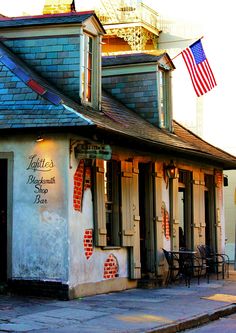 an old building with a flag on the roof