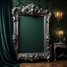 an ornate silver frame in front of a dark green wall with candles on either side