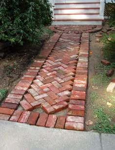 a brick walkway in front of a house