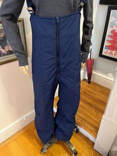 Blue padded nylon ski bib suit. waist pocket and leg pocket, it has an ankle bag to keep you warm and dry.  in perfect condition, it ships to you freshly washed and ready to wear. the straps may not be as stretchy as when It was made, but they still stretch for movement there are ribbed side panels to allow for easy movement. you don't have to ski to use these, i'd wear them for winter dog walking they say mens size L regular but compared to others in the same size these run smaller they are absolutely suitable for men or women check the measurements below to know how they will fit you  waist 34-36'' hips 36'' rise 12'' inseam 31'' a vintage or recycled item, no returns or refunds so message with us before you buy if you have any questions go to our Etsy shop to see all our other ski wear, Casual Blue Skiing Bottoms, Skiing Overalls, Ski Overalls, Blue Ski Outerwear With Pockets, Full-length Ski Bottoms For Ski Season, Ski Bibs, Suit Blue, Ski Suit, Ski Suits