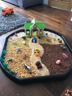 a child's play area with toys and gravel in the middle on the floor