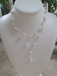 "Bridal Illusion Necklace ~ This lovely 2 strand invisible necklace is made with a white Swarovski tear pearl paired with smaller 5mm and 6mm round Swarovski pearls. Created on illusion wire, the crystals and pearls seem to float on your neck! Makes wonderful bridal jewelry or bridesmaids gift. The necklace measures approximately 15\" along the shorter strand and 17\" on the longer. An extender chain adds 2\" of length. 15\" is shorter than typical necklaces, which are 16.5\", so please contact Illusion Pearl Necklace, Pearl Back Chain, White Double Strand Pearl Necklace For Party, Delicate White Backdrop Necklace For Formal Occasions, Delicate White Backdrop Necklace For Party, White Double Strand Pearl Necklace For Wedding, White Double Strand Necklace For Party, Delicate White Single Strand Bridal Necklace, Adjustable White Pearl Drop Bridal Necklace