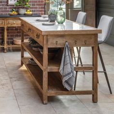 a kitchen table with two chairs and a potted plant