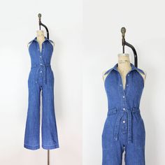 "Vintage 1970s Mushroom brand denim halter jumpsuit. Collared neck and V front with an open back. Silver tone logo snaps down the front with an denim belt at the front waist. Darted bust and fitted waist with two rounded hip pockets. Flared legs and made of a soft and medium cotton denim.  Would best fit an XS / Small  ♦ MEASUREMENTS ♦ Bust - 32\" Waist - to 29\" Hips - 37\" Length - 15.5\" (shoulder to center of waist band) and 42.5\" (center of waist band to hem) Inseam - 33\" Rise - 11.5\" (c Full Length Medium Wash Jumpsuits And Rompers For Summer, Full Length Summer Jumpsuits And Rompers In Medium Wash, Summer Full Length Medium Wash Jumpsuits And Rompers, Summer Full Length Medium Wash Jumpsuit, Retro Fitted Summer Overalls, Retro Fitted Denim Jumpsuit For Summer, Vintage Summer Overalls Jumpsuit, Vintage Sleeveless Overalls For Summer, Vintage Overall Jumpsuits And Rompers