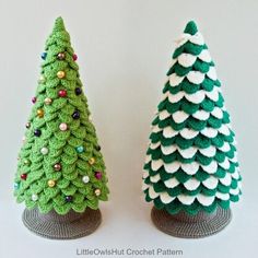 two small crocheted christmas trees sitting next to each other