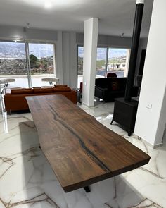 a large wooden table sitting in the middle of a living room