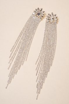 Flowing and dramatic, these long rhinestone tassel floral earrings are bold and statement-making. Pair these beauties with an off-the-shoulder top and have them sweep your shoulders gracefully. Size• Length: 6.3 in. (16 cm) • Width: 1 in. (2.5 cm) QualityPost backing earring with petal stones surrounding a centerpiece stone and flowing fringe rhinestones make this beauty so desirable. Imported EH2272 Elegant Fringe Metal Chandelier Earrings, Glamorous Tassel Earrings For Wedding, Elegant Silver Tassel Earrings For Evening, Elegant Metal Earrings With Rhinestone Fringe, Crystal Tassel Earrings For Wedding, Elegant Metal Tassel Earrings For Party, Metal Chandelier Earrings With Tassels For Party, Glamorous Crystal Tassel Earrings For Wedding, Elegant Silver Tassel Earrings For Party