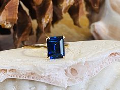 This classic 4 prong setting contains a beautiful 3.00ct. lab created emerald cut sapphire. The stone measures approximately 9x7mm. The ring is available in sterling silver, and 14k white, yellow, or rose gold.  This ring makes a great promise or engagement ring.  Please send me a message if you need a size not listed.  All items are handmade by me in my shop in Manalapan, NJ.  Please message me with any questions. Shipping within the United States is complimentary.   Thank you for exploring my Blue Sapphire Engagement Ring Gold Band, Saphire Engament Ring Emerald Cut, Rectangle Sapphire Ring, Emerald Cut Blue Sapphire Ring, Emerald Cut Sapphire Engagement Ring, Sapphire Emerald Cut Engagement Ring