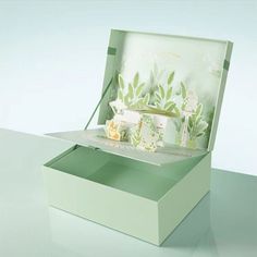 an open green box with flowers on it