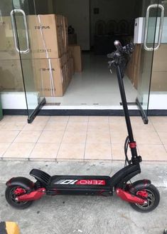 an electric scooter is parked in front of a building with boxes on the floor