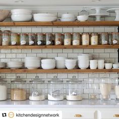 the shelves are filled with jars and bowls