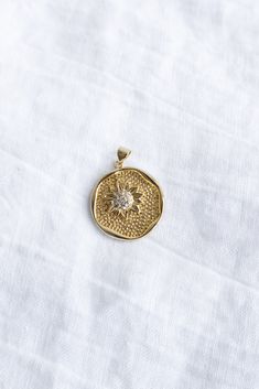 This sunflower pendant is cute, dainty, and fun to add to your favorite chain. Pair it with other chains you already have or pick out one of our dainty gold necklaces to go with it! A round gold filled pendant with a beautiful sunflower design in the middle. Size: 31.5mm x 24.7mm Approximately the size of a quarter Material: 24K Gold Filled Core: Brass One Size Available Care: polish occasionally. avoid exfoliating scrubs and chlorine. We recommend taking jewelry off for showers, swimming, & sle Batik Pillow, Sunflower Charm, Cake Stand Ceramic, Sunflower Pendant, Dainty Gold Necklace, Sunflower Design, Gold Necklaces, Gold Collection, Women Supporting Women