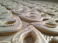 several decorated cookies sitting on top of a table next to each other with white frosting