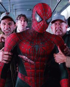 the amazing spider - man and his gang on a subway car with their arms around each other