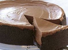 a chocolate cake on a plate with one slice cut out and ready to be eaten