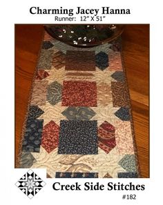 a close up of a table runner on a wooden floor with text describing the pattern