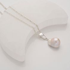 Featuring a natural baroque pearl pendant that has been carefully chosen for its one-of-a-kind shape and mesmerising iridescent lustre and hand mounted on sterling silver. This exquisite freshwater baroque pearl pendant is elegantly displayed on an 18" eco-friendly 925 sterling silver rope chain, designed to perfectly complement its natural beauty. Stunning pearl drop earrings pair with this necklace make this a perfect set of special jewellery. We want your jewellery to stay in great condition Silver Necklace With Sterling Silver Clasp And Baroque Pearl, Teardrop Baroque Pearl Pendant Necklace, Baroque Pearl Teardrop Pendant, Sterling Silver Briolette Pearl Pendant Necklace, Silver Pear-shaped Sterling Silver Pearl Necklace, Silver Pear-shaped Sterling Pearl Necklace, Sterling Silver Pear-shaped Pearl Necklace, Silver Baroque Pearl Briolette Necklace, Baroque Pearl Teardrop Pendant Necklace