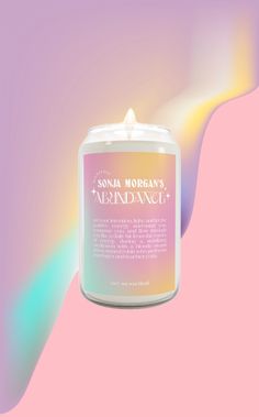 a candle that is sitting on top of a pink and blue background with the words,