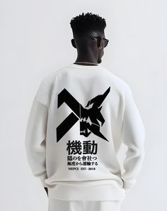 a man wearing a white sweatshirt with black graphic on the front and back, standing in front of a white background