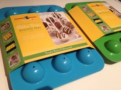 two blue and green trays with cake pops in them sitting on a counter top