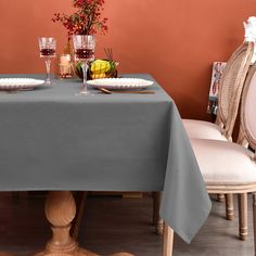 a dining room table with plates and glasses on it