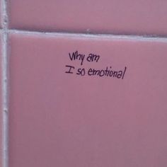 a pink tile wall with the words why am i so emotion? written on it