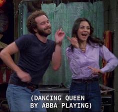 a man and woman standing next to each other in front of a mirror with the caption dancing queen by aba playing