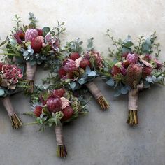 the bridal bouquets are arranged on the wall