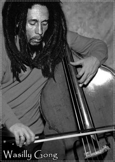 a man with dreadlocks is playing the cello