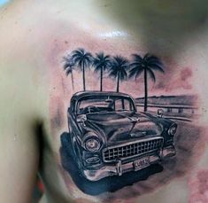 a man's chest with an old car and palm trees on it