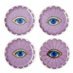 four purple plates with blue eyes and petals in the shape of an eye on them