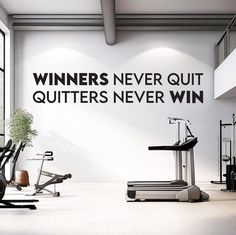 there is a gym with treadmills and exercise equipment in it, as well as a sign that says winners never quit quit