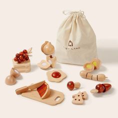 wooden toys are sitting on the floor next to a bag