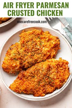 two pieces of fried parmesan chicken on a plate