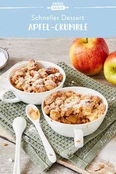 two bowls filled with apple crumble on top of a table