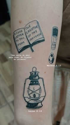 a person with a tattoo on their arm that has an open book and a lantern in it